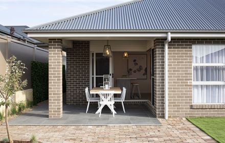 View of the outdoor alfresco area of the Avalon 220 display home opening up into the kitchen