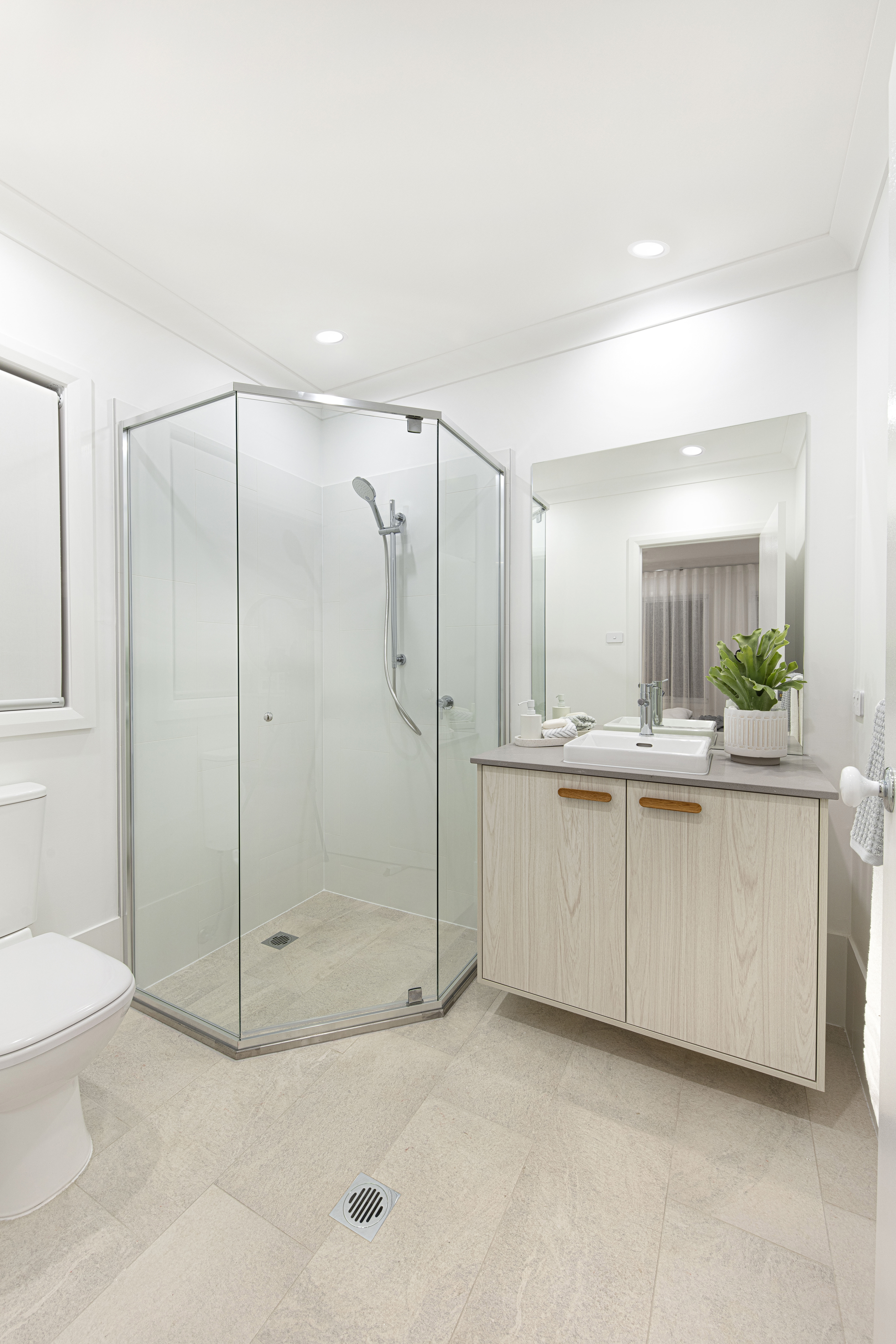 Bathroom in the Lucia One display home showing single vanity with double cupboards next to the shower