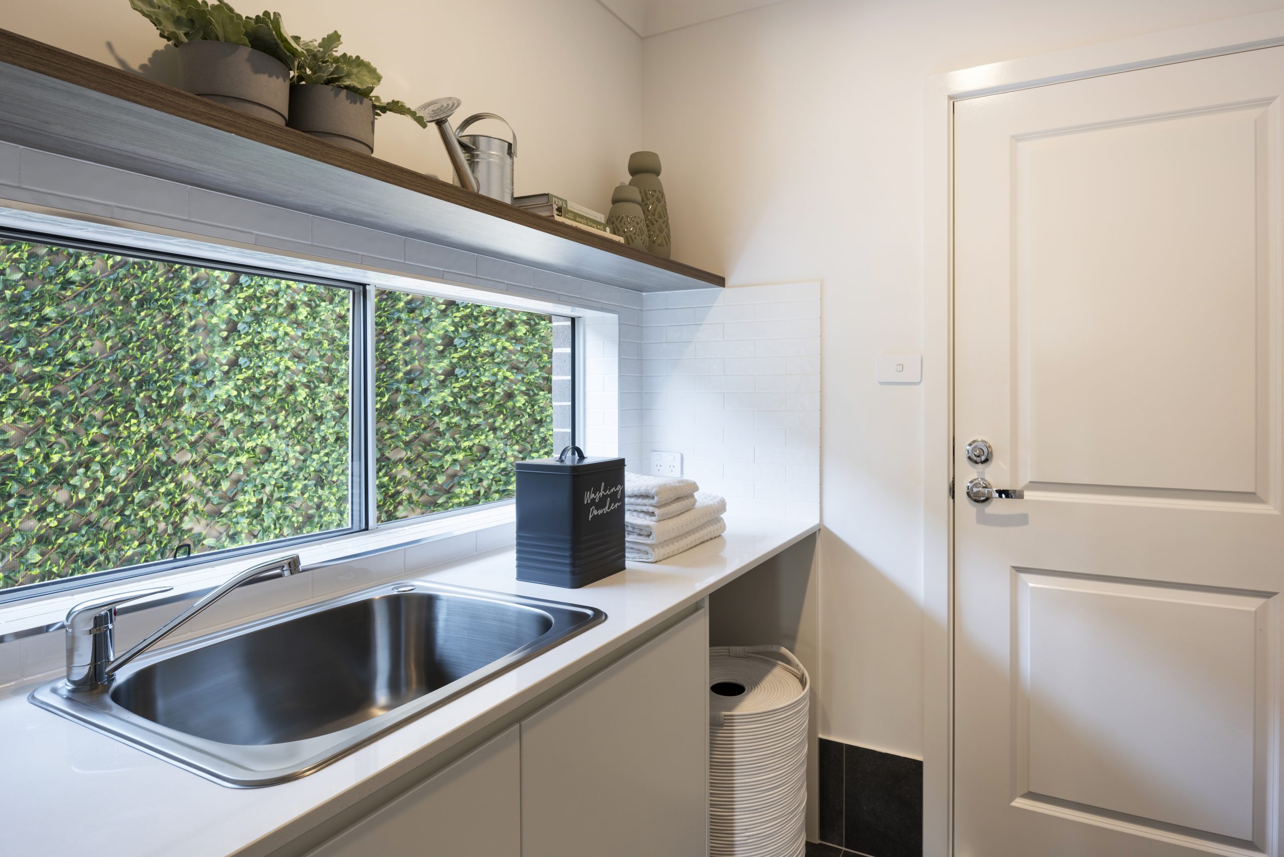 Close up of the laundry sink and cupboards in the Avalon 220 display home