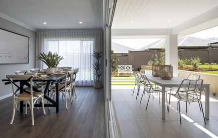 Hamptons style dining area opening up to the paved, outdoor dining area in the Avoca display home