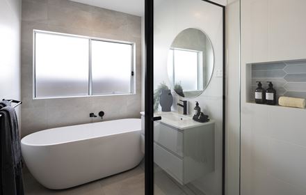 Bathroom in the Avoca display home with shower, single vanity and freestanding bathtub situated below a window