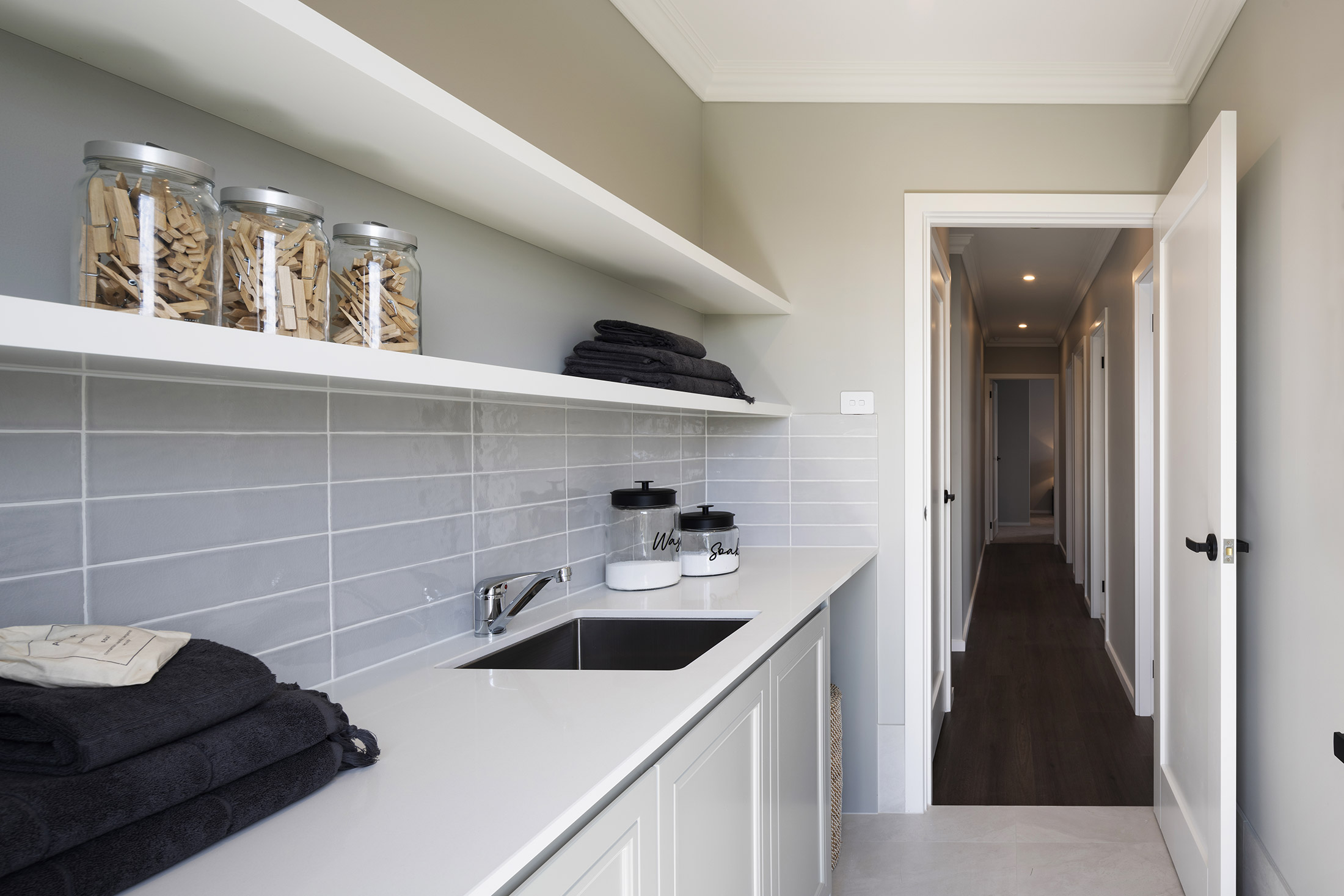 Laundry in the Avoca display home opening up to a wooden hallway