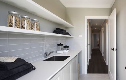Laundry in the Avoca display home opening up to a wooden hallway