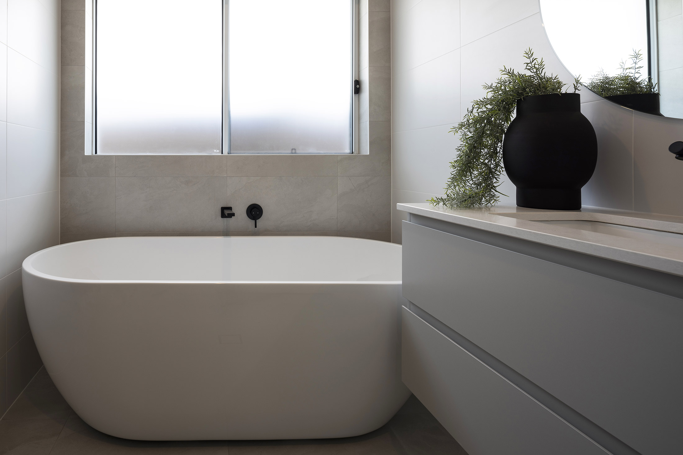 A close up of the freestanding bathtub below a window in the Avoca display home
