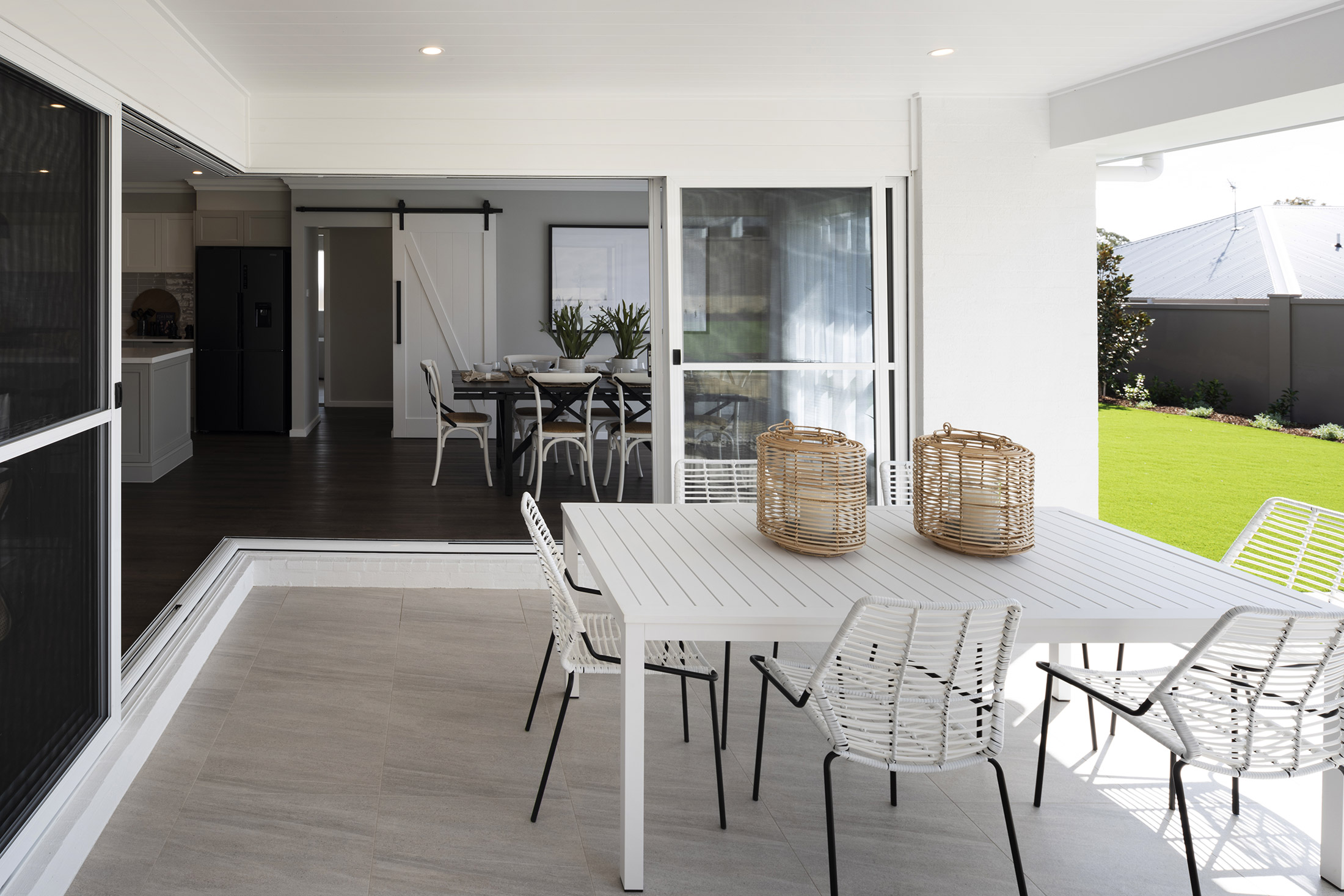 The outdoor dining area in the Avoca display with a view into the indoor dining area and kitchen 