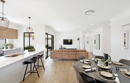 Open plan dining area opposite the kitchen and parallel to the living area in the Ellerton 223 display home