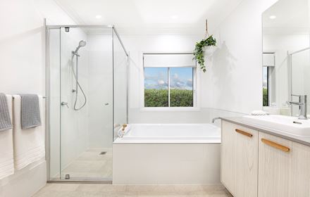 Bathroom with single vanity, built in bathtub and shower in the Lucia One display home