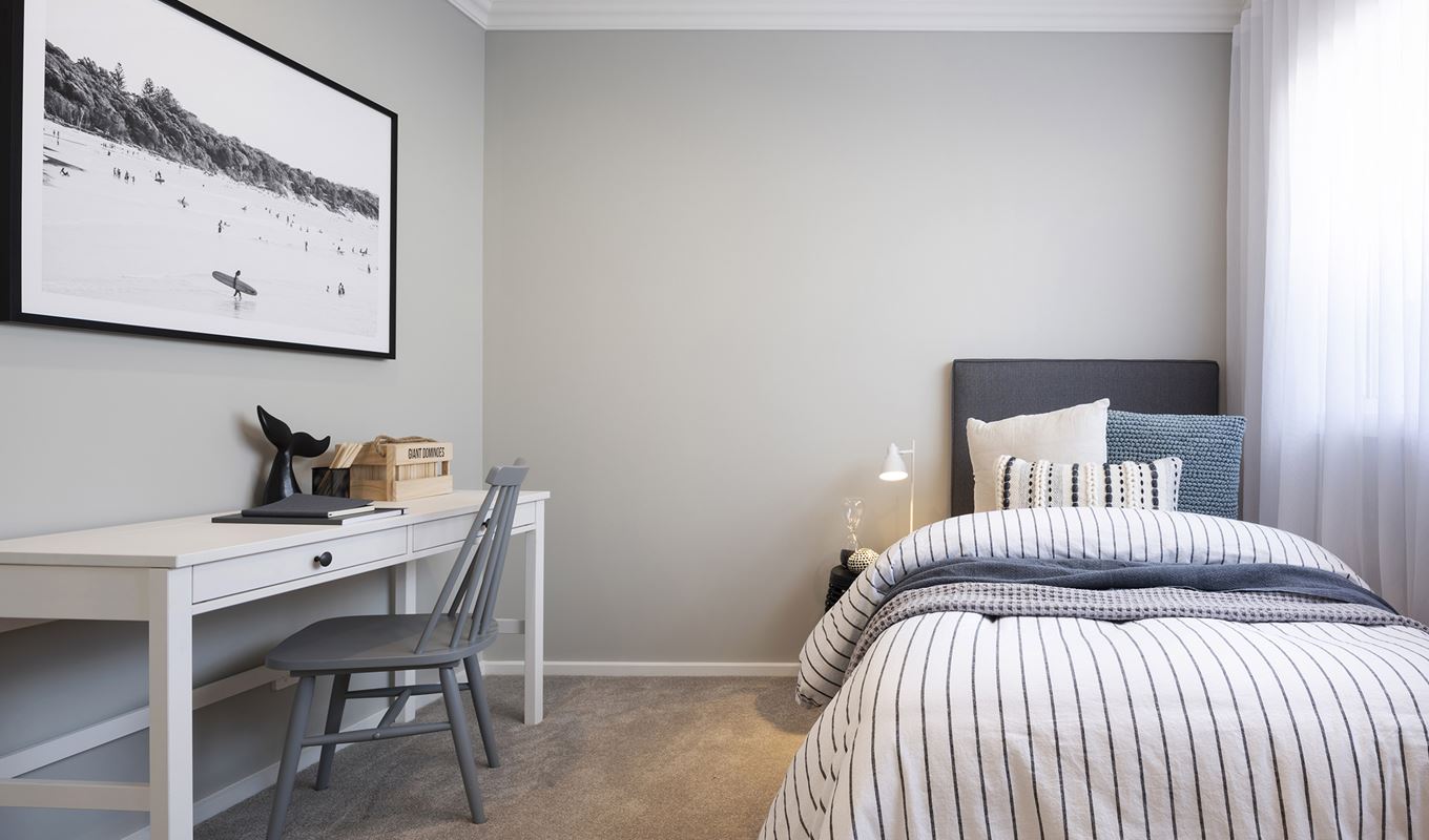 Minor bedroom in the Avoca display with single bed and bedside opposite a desk
