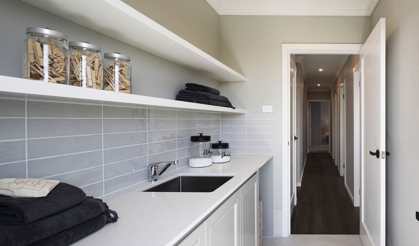 Laundry in the Avoca display home opening up to a wooden hallway
